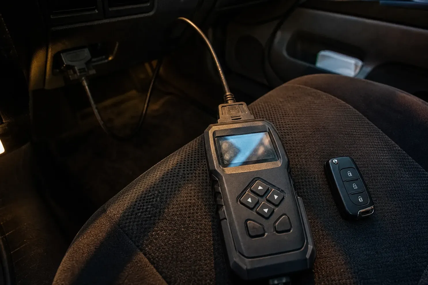 Car key programmer plugged into the OBD port, Renton, WA